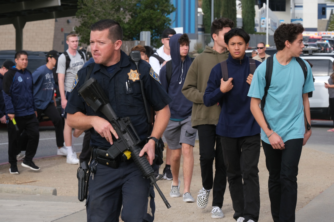 Police Officer escorting students